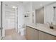Modern bathroom with toilet, floating shelves and access to a large closet at 301 Quay Commons # 1209, Sarasota, FL 34236