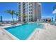 Modern pool area with plenty of lounge chairs at 301 Quay Commons # 1209, Sarasota, FL 34236