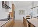 Modern kitchen with island, stainless steel appliances, and light wood cabinets at 301 Quay Commons # 1209, Sarasota, FL 34236