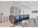 Modern bar with blue stools and decorative shelving at 301 Quay Commons # 1209, Sarasota, FL 34236