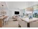 Elegant dining area with modern light fixture and city views at 301 Quay Commons # 1209, Sarasota, FL 34236