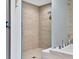 Spacious walk-in shower with neutral tile and glass enclosure at 301 Quay Commons # 1209, Sarasota, FL 34236