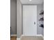Bright entryway with white door and floating shelves at 301 Quay Commons # 1209, Sarasota, FL 34236