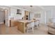 Modern kitchen with island, stainless steel appliances, and light wood cabinets at 301 Quay Commons # 1209, Sarasota, FL 34236