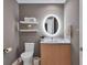 Modern powder room with sleek vanity, illuminated mirror, and floating shelves at 301 Quay Commons # 1209, Sarasota, FL 34236