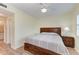 Bedroom with wood floors, large bed, and access to bathroom at 2625 Terra Ceia Bay Blvd # 205, Palmetto, FL 34221