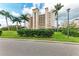 Condo building with lush landscaping and palm trees at 2625 Terra Ceia Bay Blvd # 205, Palmetto, FL 34221