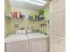 Laundry room with washer, dryer, and overhead shelving at 2625 Terra Ceia Bay Blvd # 205, Palmetto, FL 34221
