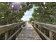 Wooden dock extending over tranquil water with mangrove trees at 2625 Terra Ceia Bay Blvd # 205, Palmetto, FL 34221