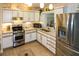 Modern kitchen with stainless steel appliances and light wood cabinets at 22119 Laramore Ave, Port Charlotte, FL 33952