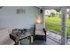 Relaxing screened porch with seating area and view of backyard at 22119 Laramore Ave, Port Charlotte, FL 33952