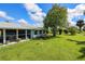 Large backyard with a screened patio and lush lawn at 22119 Laramore Ave, Port Charlotte, FL 33952