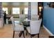 Bright dining area with a glass-top table and four chairs at 22119 Laramore Ave, Port Charlotte, FL 33952