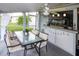 Outdoor patio with dining area and bar, ceiling fan at 22119 Laramore Ave, Port Charlotte, FL 33952
