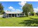 Spacious backyard with screened porch and lawn at 22119 Laramore Ave, Port Charlotte, FL 33952