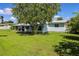 Backyard with screened porch and a large lawn at 22119 Laramore Ave, Port Charlotte, FL 33952