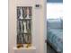 Built-in shelving with decorative figurines and a view into a bedroom with a teal and white comforter at 22119 Laramore Ave, Port Charlotte, FL 33952