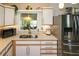 Updated kitchen with stainless steel appliances and a large island at 22119 Laramore Ave, Port Charlotte, FL 33952