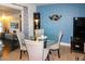 Casual dining area features a round glass table and four light grey chairs at 22119 Laramore Ave, Port Charlotte, FL 33952