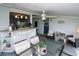 Screened patio with dining and seating areas, ceiling fan at 22119 Laramore Ave, Port Charlotte, FL 33952