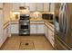 Modern kitchen with stainless steel appliances and light wood cabinets at 22119 Laramore Ave, Port Charlotte, FL 33952