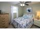 Cozy bedroom with light blue bedding and a ceiling fan at 22119 Laramore Ave, Port Charlotte, FL 33952