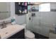 Bathroom with a walk-in shower, white tile, and dark vanity at 22119 Laramore Ave, Port Charlotte, FL 33952