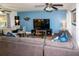 Living room features a sectional sofa and a large flat-screen tv at 22119 Laramore Ave, Port Charlotte, FL 33952