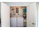 Clean laundry room, washer, dryer, and storage shelves at 22119 Laramore Ave, Port Charlotte, FL 33952