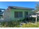 Damaged light green house with exposed framing at 108 Sago Ln, Nokomis, FL 34275