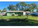 Small green house with damaged roof and overgrown yard at 108 Sago Ln, Nokomis, FL 34275