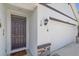 Front entryway with a dark brown door and white garage door at 5120 Vecchio Ct, Bradenton, FL 34211