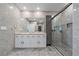 Modern bathroom featuring double sinks, a large shower, and stylish gray tile at 5120 Vecchio Ct, Bradenton, FL 34211