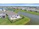 Aerial view of house with backyard patio and lake view at 5120 Vecchio Ct, Bradenton, FL 34211