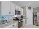 Bright kitchen with stainless steel appliances and white cabinets at 5120 Vecchio Ct, Bradenton, FL 34211