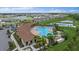 Aerial view of community pool, clubhouse, and surrounding homes at 5120 Vecchio Ct, Bradenton, FL 34211