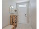 Entryway with a wooden bench and coat rack at 5120 Vecchio Ct, Bradenton, FL 34211