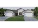 Two-car garage and farmhouse-style home at 18860 Dayspring Pl, Venice, FL 34293