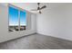 Bright bedroom with large window, wood-look floors and a ceiling fan at 111 S Pineapple Ave # 1021, Sarasota, FL 34236