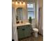 Bathroom featuring modern vanity with sleek hardware, designer mirror, shower and stylish accents at 11709 Capstan Pl, Parrish, FL 34219