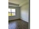 A bright, airy bedroom with hardwood floors and large window with views of a pond at 11709 Capstan Pl, Parrish, FL 34219