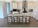 Bright, modern kitchen features a central island with a sink, stylish bar stool seating and stainless steel appliances at 11709 Capstan Pl, Parrish, FL 34219