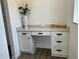 A cozy office nook is equipped with a built-in desk, drawers, and cabinetry for stylish storage at 11709 Capstan Pl, Parrish, FL 34219
