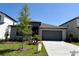 Attractive single-story home showcasing modern architecture, a well-manicured lawn, and a gray two-car garage at 11718 Capstan Pl, Parrish, FL 34219