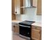 New black glass cooktop in a kitchen with cabinets, white countertops, and white tiled backsplash at 11718 Capstan Pl, Parrish, FL 34219