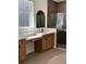 Bathroom featuring double sinks, a vanity area, and a frameless glass shower for modern luxury at 11718 Capstan Pl, Parrish, FL 34219