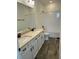 Bathroom featuring a double sink vanity with quartz counters and wood tile flooring at 11722 Capstan Pl, Parrish, FL 34219