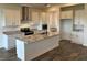 Open concept kitchen featuring a large island with granite countertops, stainless steel appliances, and wood tile flooring at 11722 Capstan Pl, Parrish, FL 34219
