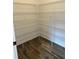 Walk in pantry with wood look tile floor and adjustable metal shelving at 11722 Capstan Pl, Parrish, FL 34219