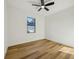 Bedroom features natural light from the window and wood-look floors at 2382 Carpenter Ln, North Port, FL 34286